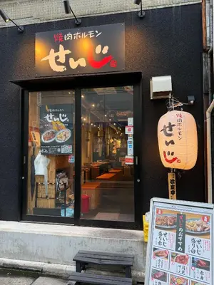 a restaurant with a sign in front of a window at Pagi Hotel in Tokyo