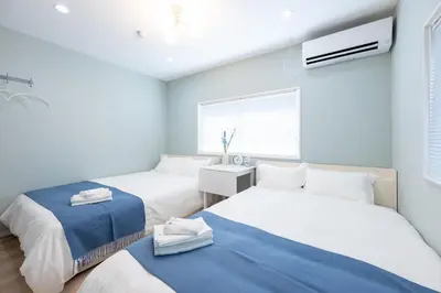 a bedroom with two beds and a window at 長期割がお得 最大8名 2BR 55平米 東京駅電車10分 TDR スカイツリー好アクセス 駐車場予約 送迎有 HOTEL DREAM MUSIC Tōyōchō pastel in Tokyo
