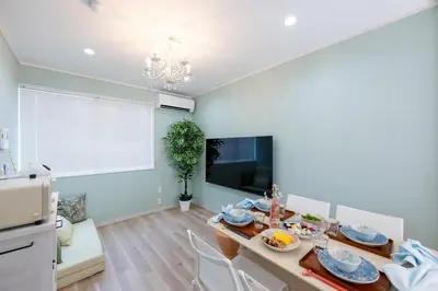 a kitchen and dining room with a table and chairs at 長期割がお得 最大8名 2BR 55平米 東京駅電車10分 TDR スカイツリー好アクセス 駐車場予約 送迎有 HOTEL DREAM MUSIC Tōyōchō pastel in Tokyo
