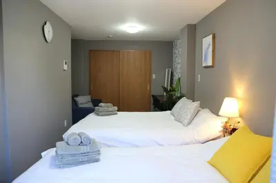 two beds in a hotel room with towels on them at M206 Easy access to Ikebukuro, Ginza, Shinjuku in Tokyo