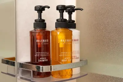 three bottles of oil sitting on a shelf at Skytree Tokyo Apartment Ohanachaya in Tokyo