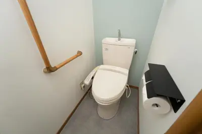 a small bathroom with a toilet and a paper dispenser at Skytree Tokyo Apartment Ohanachaya in Tokyo