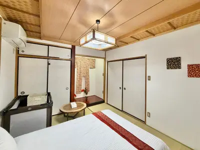 a bedroom with a bed and a table and a chair at Skytree Tokyo Apartment Ohanachaya in Tokyo