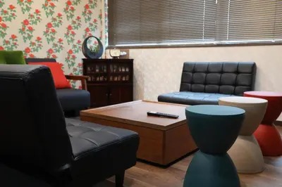 a living room with a couch and a coffee table at 長期割がお得 最大12名 2BR 70平米 東京駅電車10分 TDR スカイツリー好アクセス 駐車場予約 送迎有 HOTEL DREAM MUSIC Tōyōchō japanese-modern in Tokyo