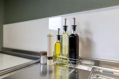 two bottles of wine sitting on top of a kitchen counter at 長期割がお得 最大12名 2BR 70平米 東京駅電車10分 TDR スカイツリー好アクセス 駐車場予約 送迎有 HOTEL DREAM MUSIC Tōyōchō japanese-modern in Tokyo