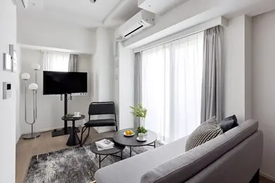 a living room with a couch and a tv at \u30a2\u30fc\u30d0\u30cd\u30c3\u30af\u30b9\u9326\u7cf8\u516c\u5712ll in Tokyo