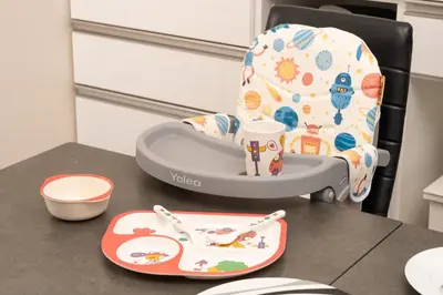 a baby chair sitting on a table with a plate at Skytree Tokyo Residence Aoto in Tokyo
