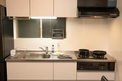 a kitchen with a sink and a stove at Skytree Tokyo Residence Aoto in Tokyo