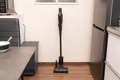 a black vacuum in the corner of a kitchen at Skytree Tokyo Residence Aoto in Tokyo