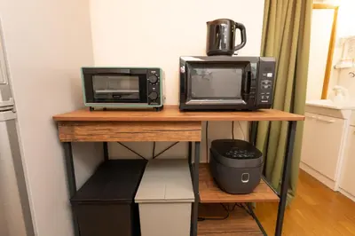 two microwaves and a microwave on a table at Skytree Tokyo House Takasago in Tokyo