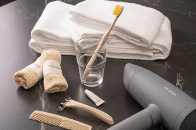 a glass with a toothbrush and towels on a table at Skytree Tokyo House Takasago in Tokyo