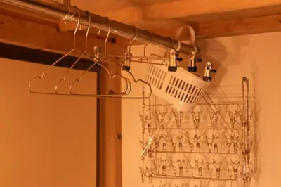 a basket of wine glasses hanging from a ceiling at Skytree Tokyo House Takasago in Tokyo