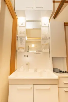 a bathroom with a sink and a mirror at Skytree Tokyo House Takasago in Tokyo
