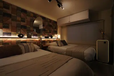 a hotel room with two beds and a mirror at C's Tiny House , 2 double beds , smart stay , near Tokyo Skytree in Tokyo