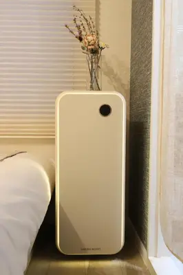 a white cell phone sitting on the floor next to a bed at C's Tiny House , 2 double beds , smart stay , near Tokyo Skytree in Tokyo