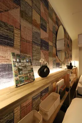 a hotel room with a wall covered in tiles at C's Tiny House , 2 double beds , smart stay , near Tokyo Skytree in Tokyo