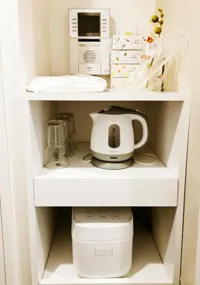 a kitchen shelf with a microwave and a toilet at Fukuda House Shinjuku in Tokyo