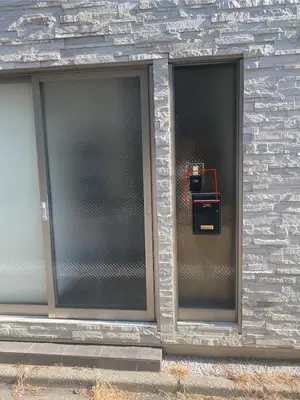two glass windows on a brick building with a pay phone at New Up to 10 people OK! 30-second walk from the station exit! Superhosts are here to help you in a polite and prompt manner! Rest assured stay! in Tokyo