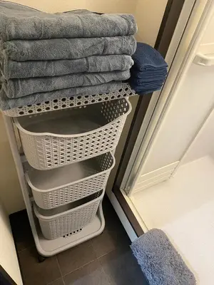 a laundry room with a rack of towels at New Up to 10 people OK! 30-second walk from the station exit! Superhosts are here to help you in a polite and prompt manner! Rest assured stay! in Tokyo