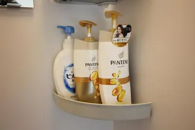a shelf in a bathroom with bottles of cleaning products at New Up to 10 people OK! 30-second walk from the station exit! Superhosts are here to help you in a polite and prompt manner! Rest assured stay! in Tokyo