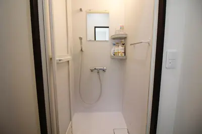 a bathroom with a shower and a mirror at New Up to 10 people OK! 30-second walk from the station exit! Superhosts are here to help you in a polite and prompt manner! Rest assured stay! in Tokyo