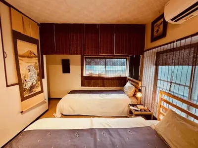 a bedroom with two beds and a window at ViVo\u9280\u5ea7 in Tokyo