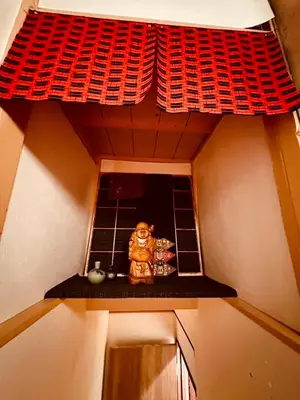 a small kitchen with a figurine on a shelf at ViVo\u9280\u5ea7 in Tokyo