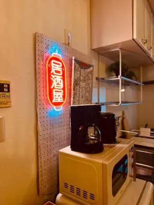 a neon sign sitting on top of a microwave at ViVo\u9280\u5ea7 in Tokyo