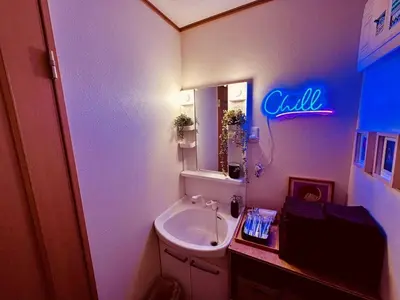 a bathroom with a sink and a sign that says chill at ViVo\u9280\u5ea7 in Tokyo
