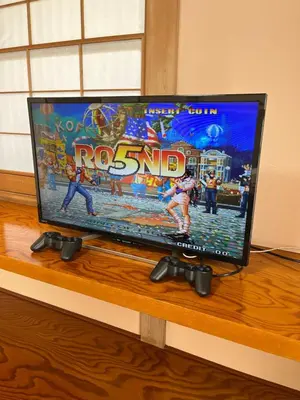 a flat screen tv sitting on top of a wooden table at Japan Harry Potter Guesthouse in Tokyo