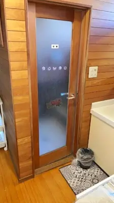 a glass door in a room with a refrigerator at Japan Harry Potter Guesthouse in Tokyo