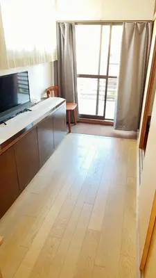 a kitchen with a wooden floor and a large window at Japan Harry Potter Guesthouse in Tokyo