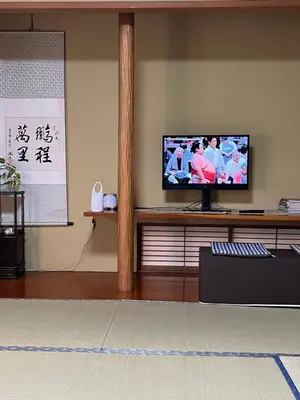 a living room with a flat screen tv on a shelf at Japan Harry Potter Guesthouse in Tokyo