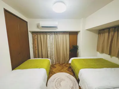 a hotel room with two beds and a window at 4min to \u6771\u65b0\u5bbfShinjuku in Tokyo