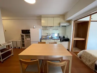 a kitchen with a wooden table in a room at Shibuya myroom in Tokyo