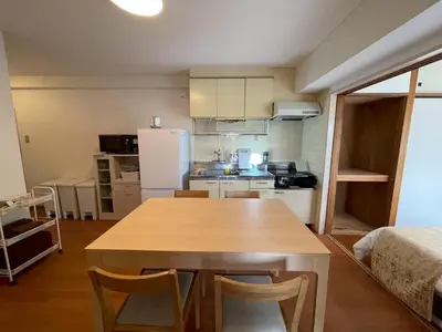 a kitchen with a wooden table in a room at Shibuya myroom in Tokyo