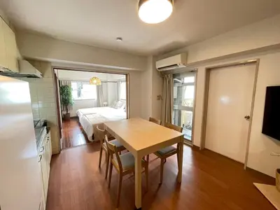 a dining room with a table and a bedroom at Shibuya myroom in Tokyo
