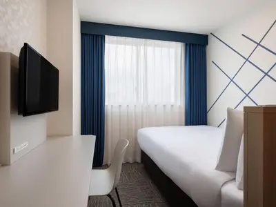 a hotel room with a bed and a tv at Four Points Flex by Sheraton Tokyo Higashi Kanda in Tokyo