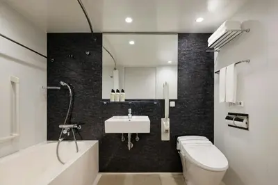 a bathroom with a toilet and a sink and a tub at Four Points Flex by Sheraton Tokyo Higashi Kanda in Tokyo