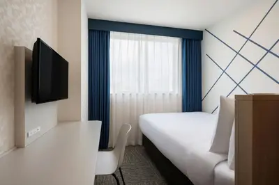 a hotel room with a bed and a tv at Four Points Flex by Sheraton Tokyo Higashi Kanda in Tokyo
