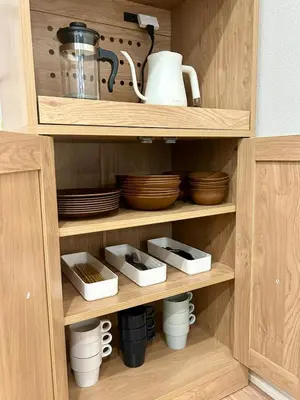 a wooden cupboard with dishes and plates in it at Shinjuku Area 3 Bedroom House in Tokyo