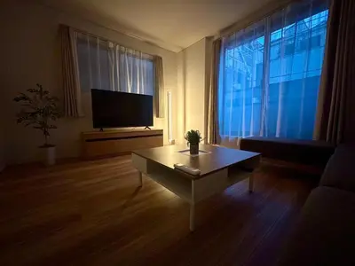 a living room with a tv and a coffee table at Shinjuku Area 3 Bedroom House in Tokyo