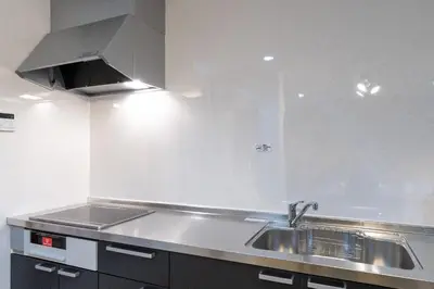 a kitchen with a sink and a stainless steel counter top at mt \u4e2d\u91ce\u30d3\u30eb in Tokyo