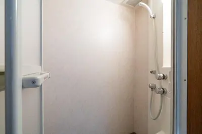 a bathroom with a shower with a glass door at mt \u4e2d\u91ce\u30d3\u30eb in Tokyo