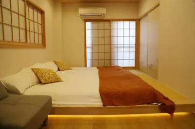 a bedroom with a bed and a couch and a window at M208 Easy access to Ikebukuro Red Leaves ,Golden Ginkgo in Tokyo