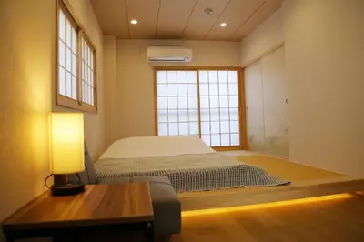 a bedroom with a bed and a table and a window at M208 Easy access to Ikebukuro Red Leaves ,Golden Ginkgo in Tokyo