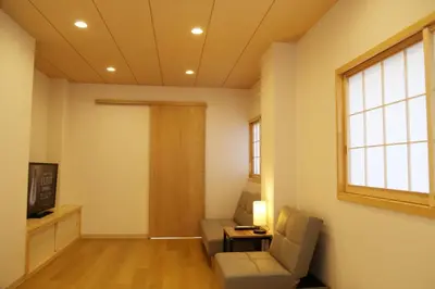 a living room with a couch and a chair and a television at M208 Easy access to Ikebukuro Red Leaves ,Golden Ginkgo in Tokyo