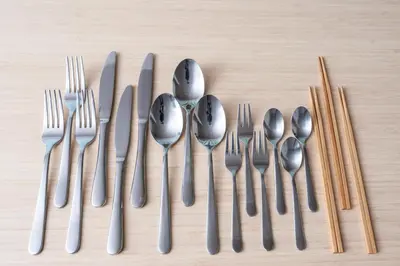 a group of forks knives and spoons on a table at Enjoy Meguro House in Tokyo