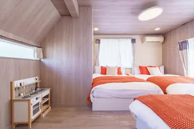 a bedroom with two beds and a window at Enjoy Meguro House in Tokyo