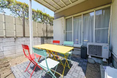a table and chairs on the patio of a house at Enjoy Meguro House in Tokyo